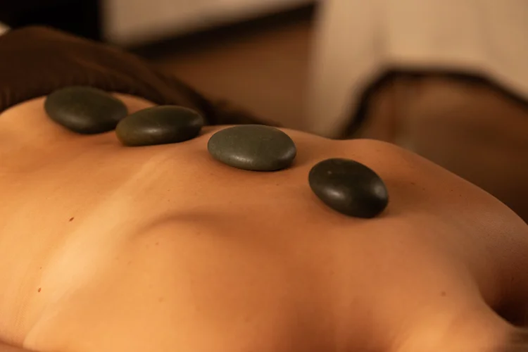 Hot stones on a client's back