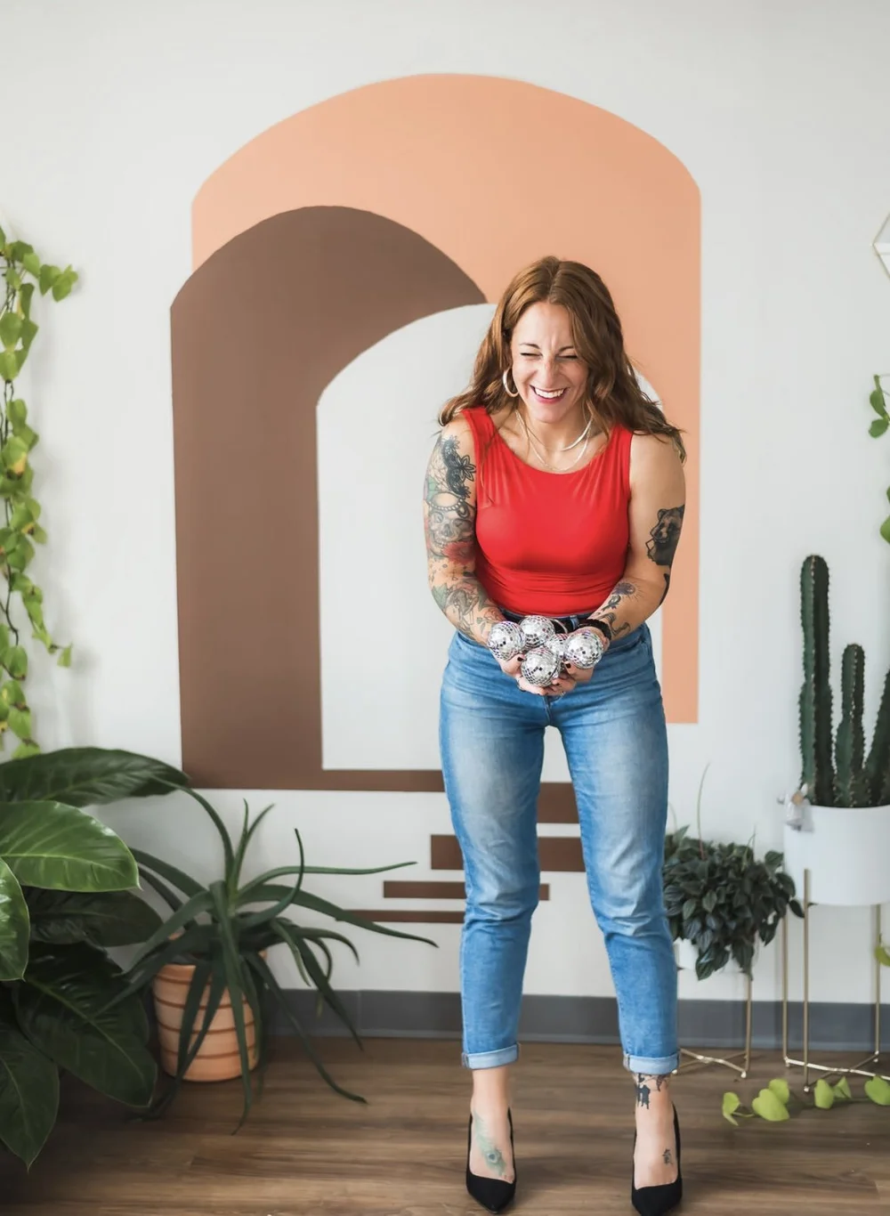 Katie Walker, licensed massage therapist in Wilmington NC, laughing in her studio