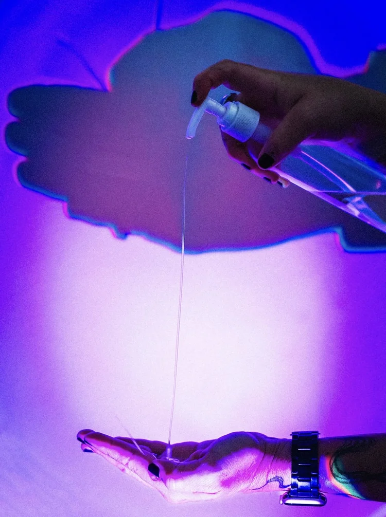 Massage oil being pumped under neon light