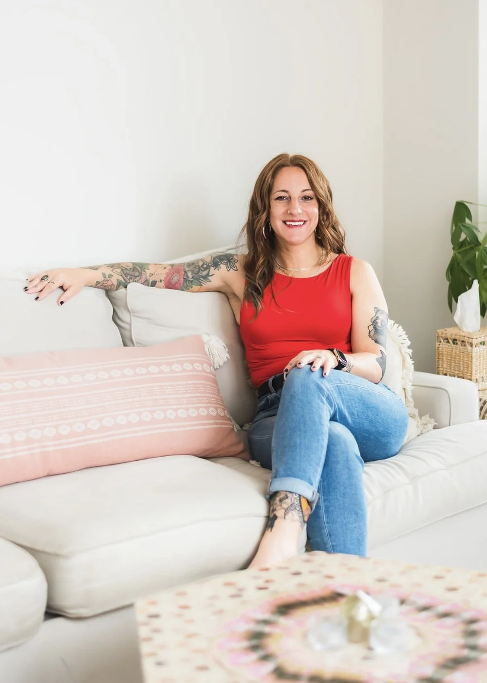 Katie Walker, licensed massage therapist, smiling in a red top