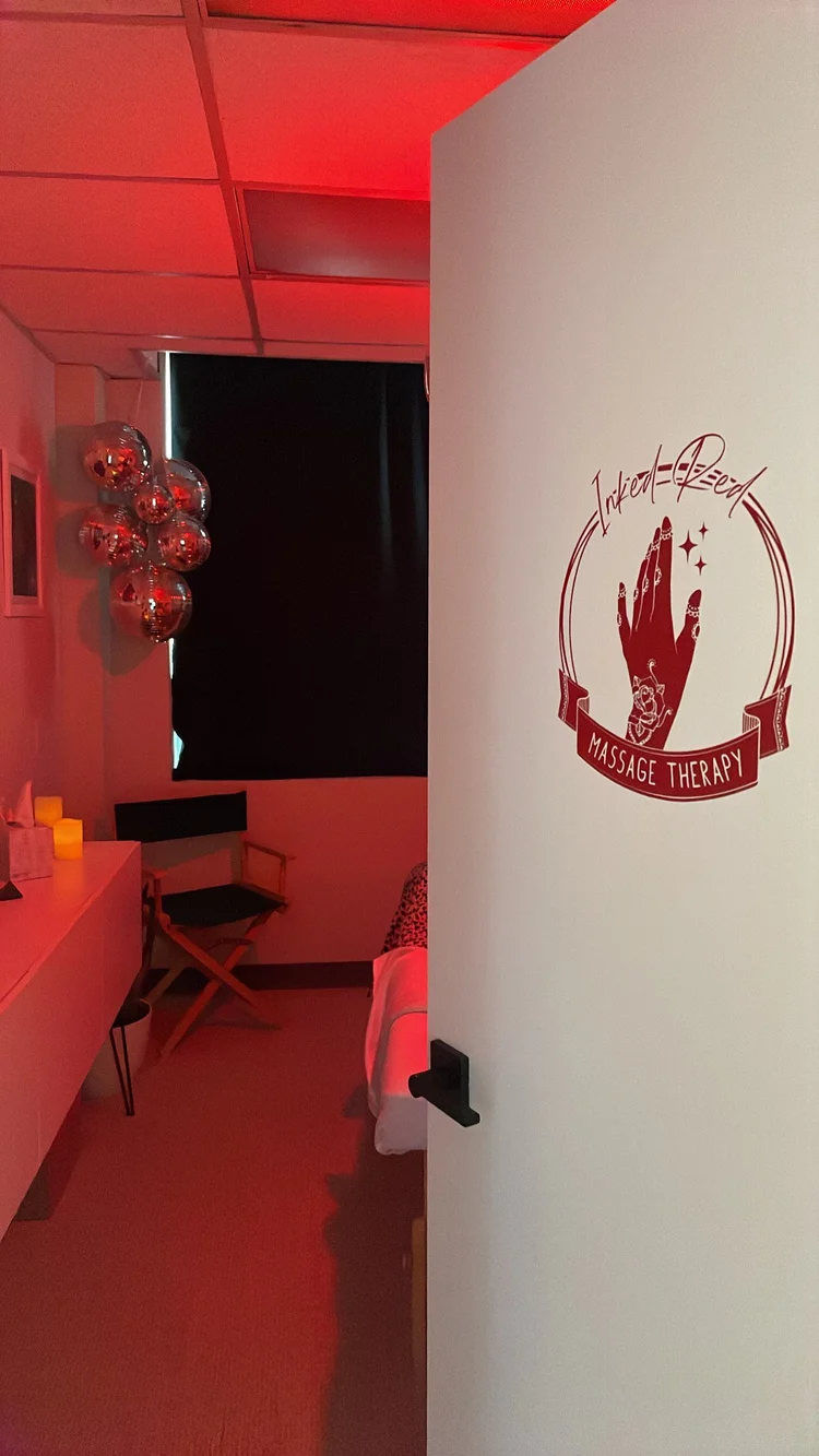 Treatment room door with Inked Red logo under red light
