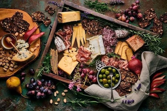 Charcuterie board with cured meats, cheeses, fruit and crackers