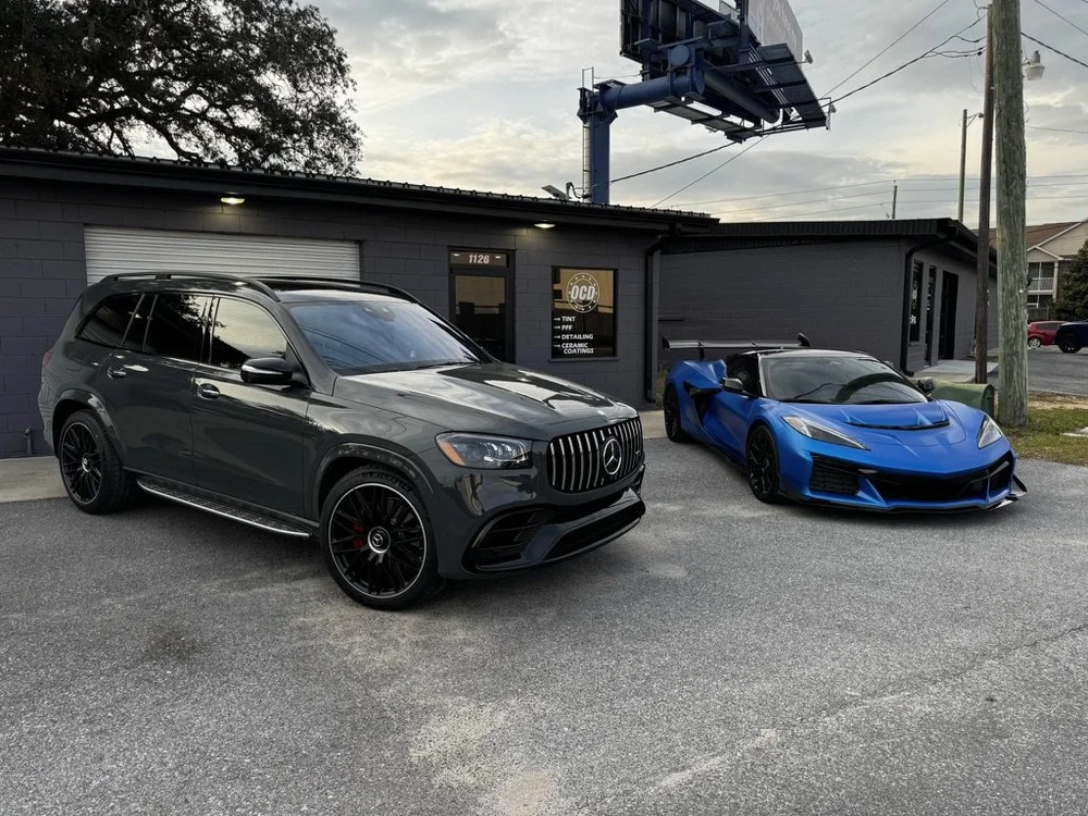 Mercedes-AMG GLS 63 and Corvette Z06 at dusk outside OCD Tinting & Wraps, Fort Walton Beach