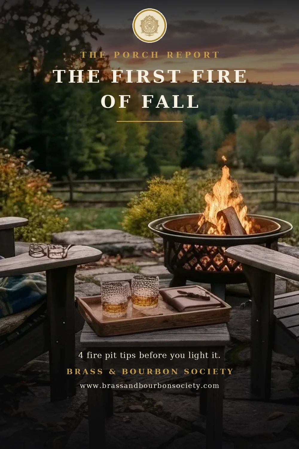Two Adirondack chairs beside a crackling fire pit on a stone patio at dusk, a blanket over one chair and autumn trees beyond