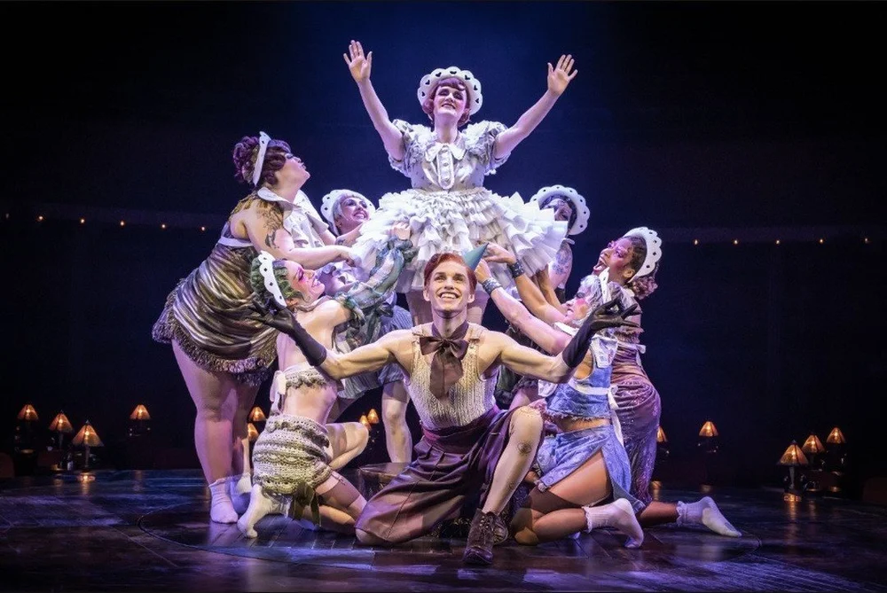 Gayle Rankin as Sally Bowles lifted above the Kit Kat Club dancers, with Eddie Redmayne as the Emcee kneeling in front