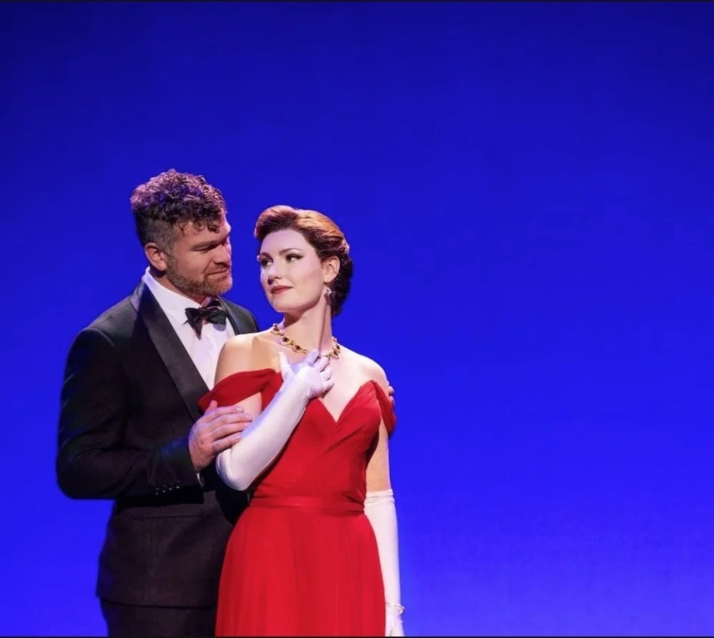 Chase Wolfe as Edward holds Ellie Baker as Vivian, in the red gown, in the Pretty Woman tour