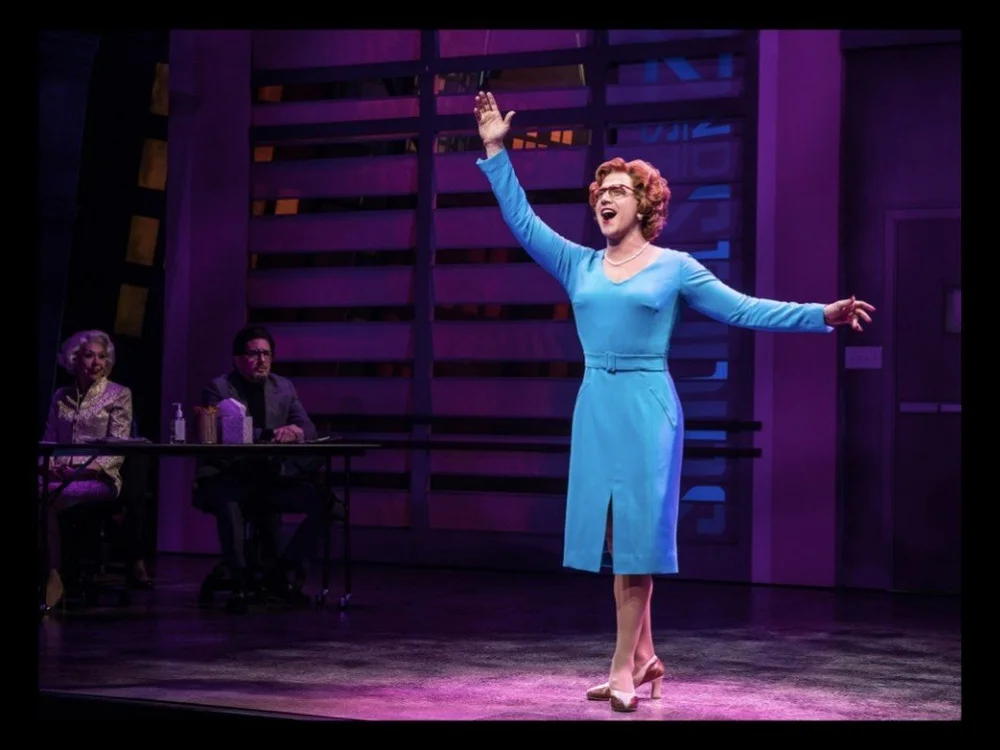 Santino Fontana as Dorothy Michaels in a blue dress, arms flung wide, in Tootsie on Broadway