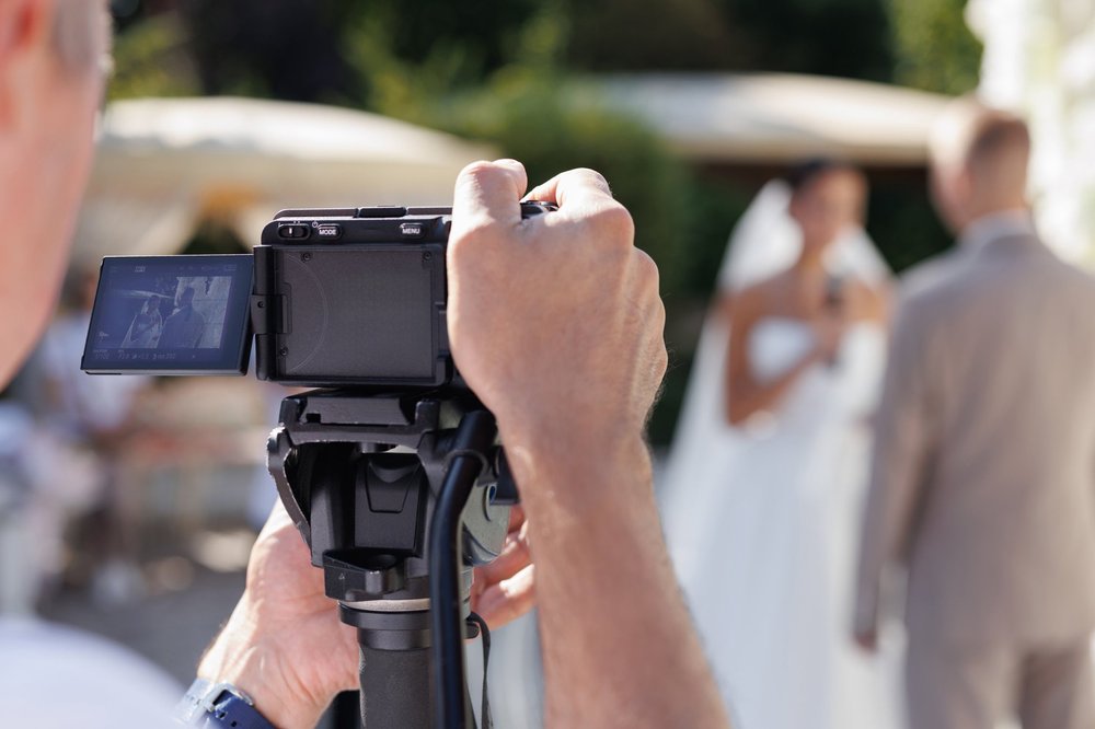 Videographer filming a wedding ceremony