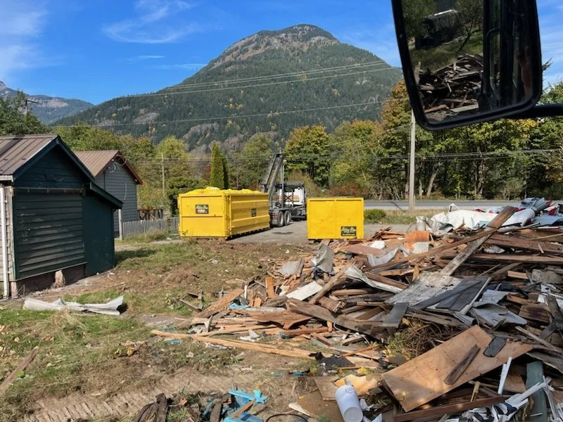 Demolition materials and collection bins during a British Columbia site preparation project