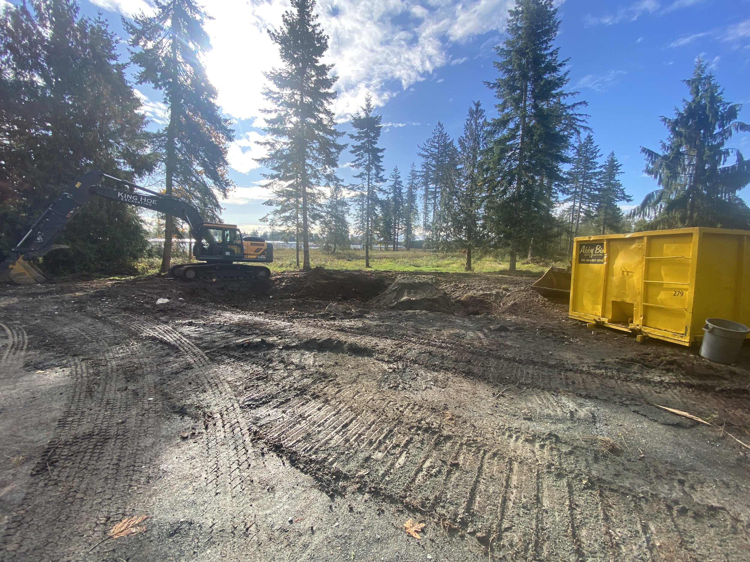 Excavator and earthworks at a Fraser Valley site preparation project