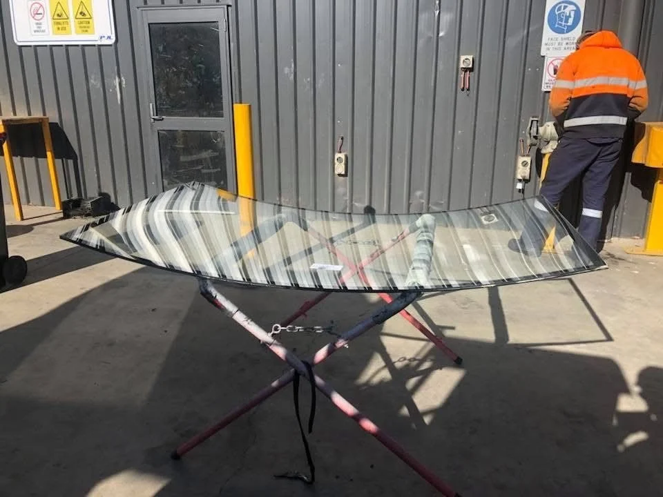 New windscreen on a stand in the Orange Auto Glass workshop ready to be fitted