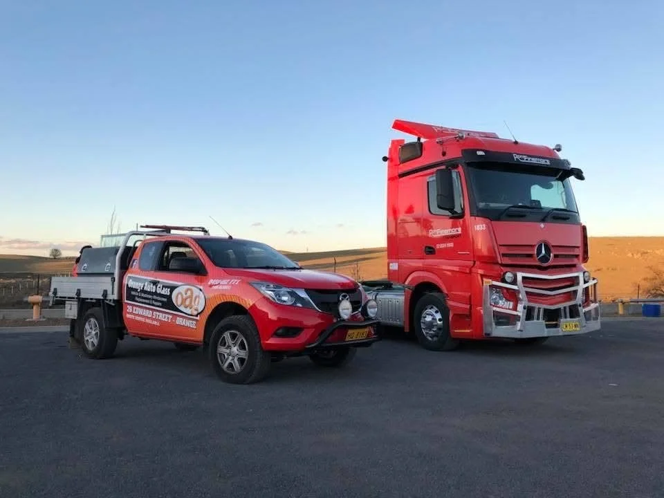 Mercedes-Benz prime mover with the Orange Auto Glass service ute alongside, ready for a truck windscreen replacement