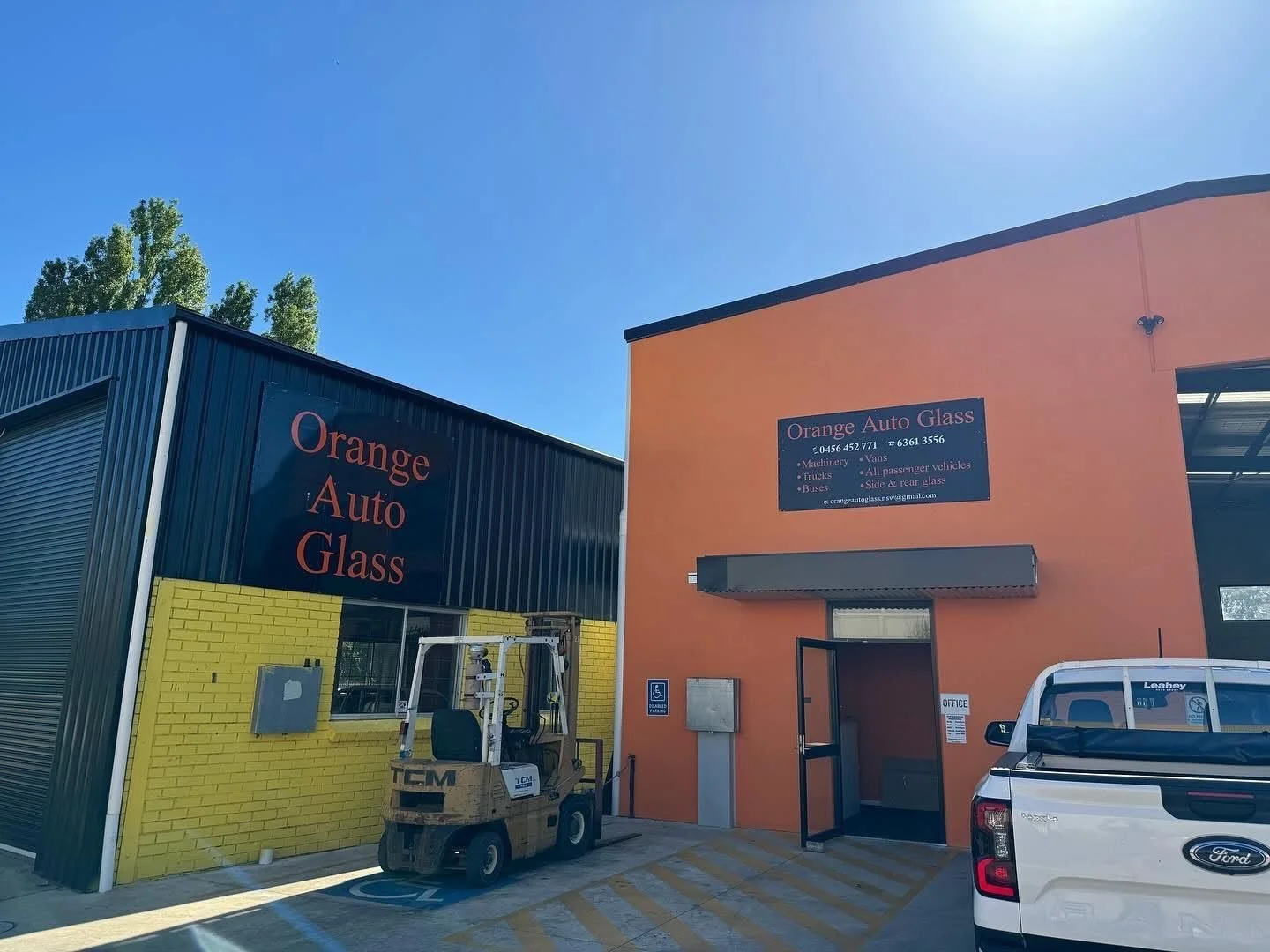Orange Auto Glass workshop buildings at 26 Edward Street, Orange, with a forklift and ute in the yard