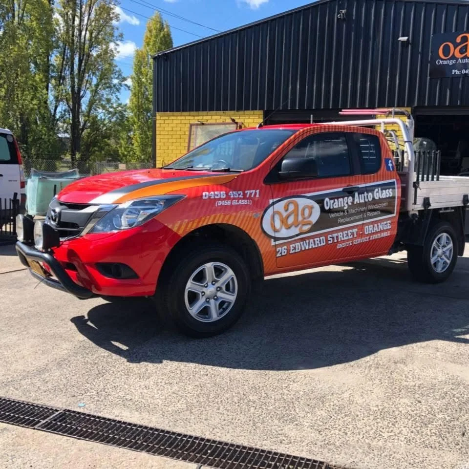 Orange Auto Glass service ute with onsite service signage parked at the Edward Street workshop