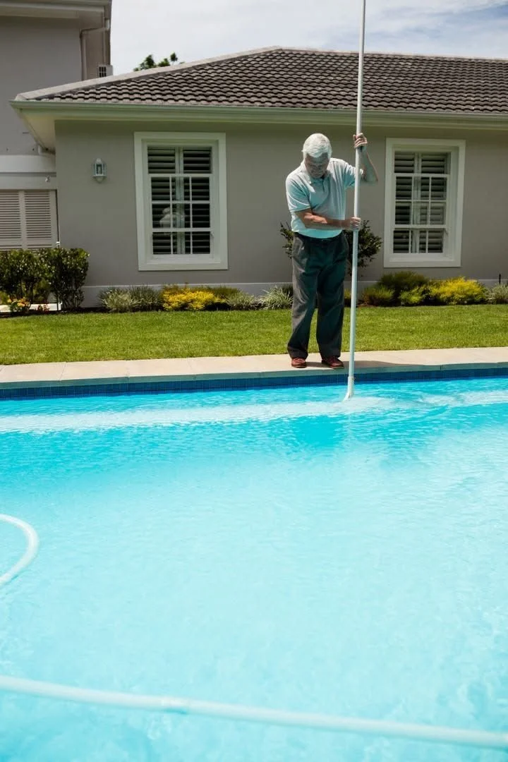 Technician brushing a pool