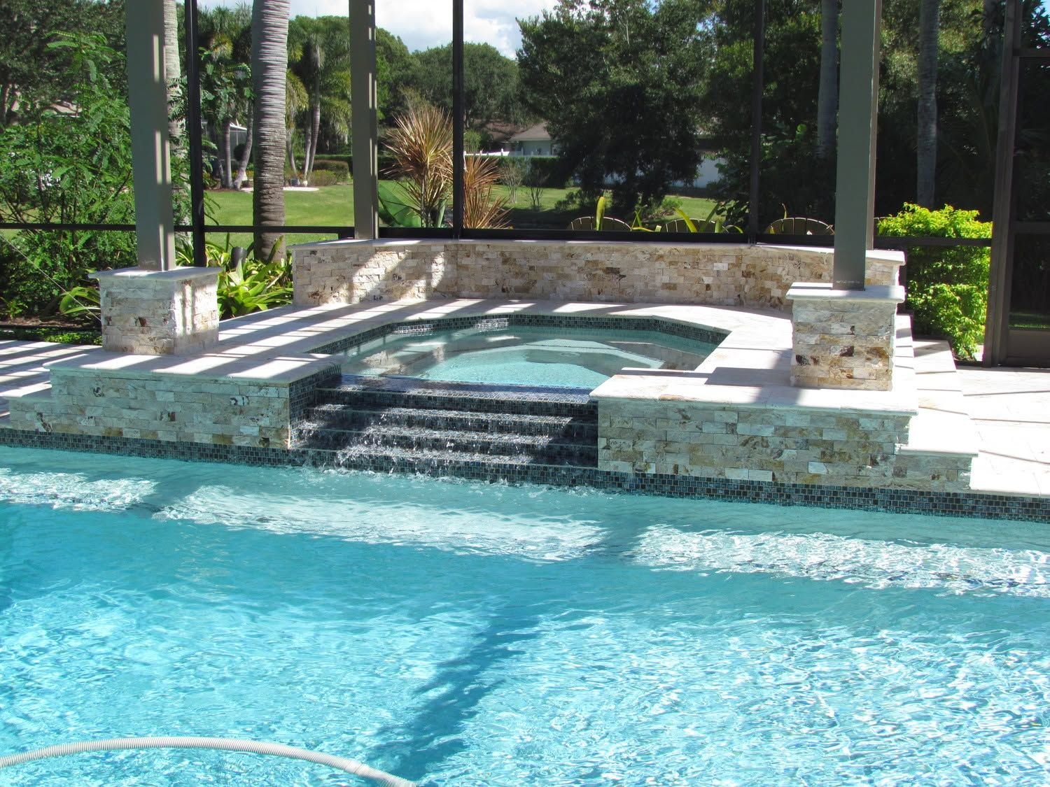 Raised spa beside a pool