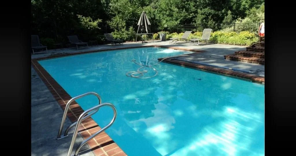 Pool with trees and a hand rail