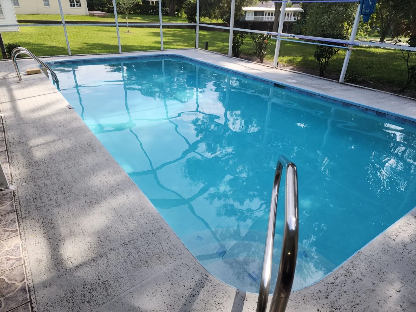 Pool with a ladder and skimmer side