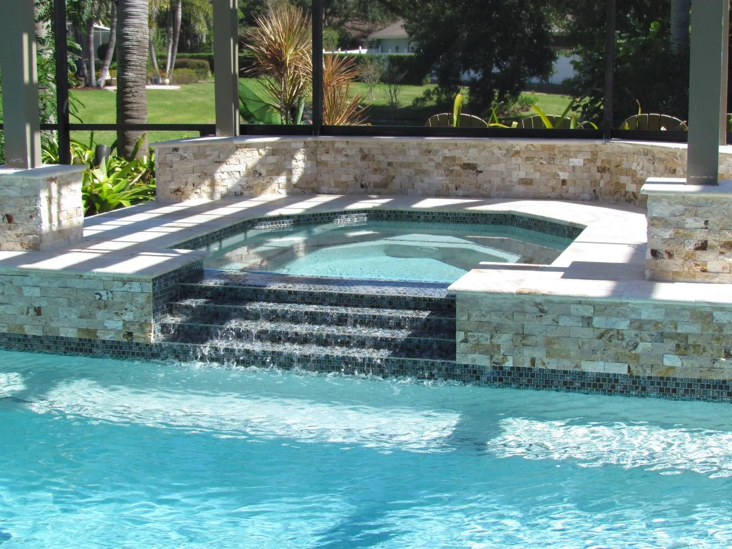 Raised spa spilling into a pool
