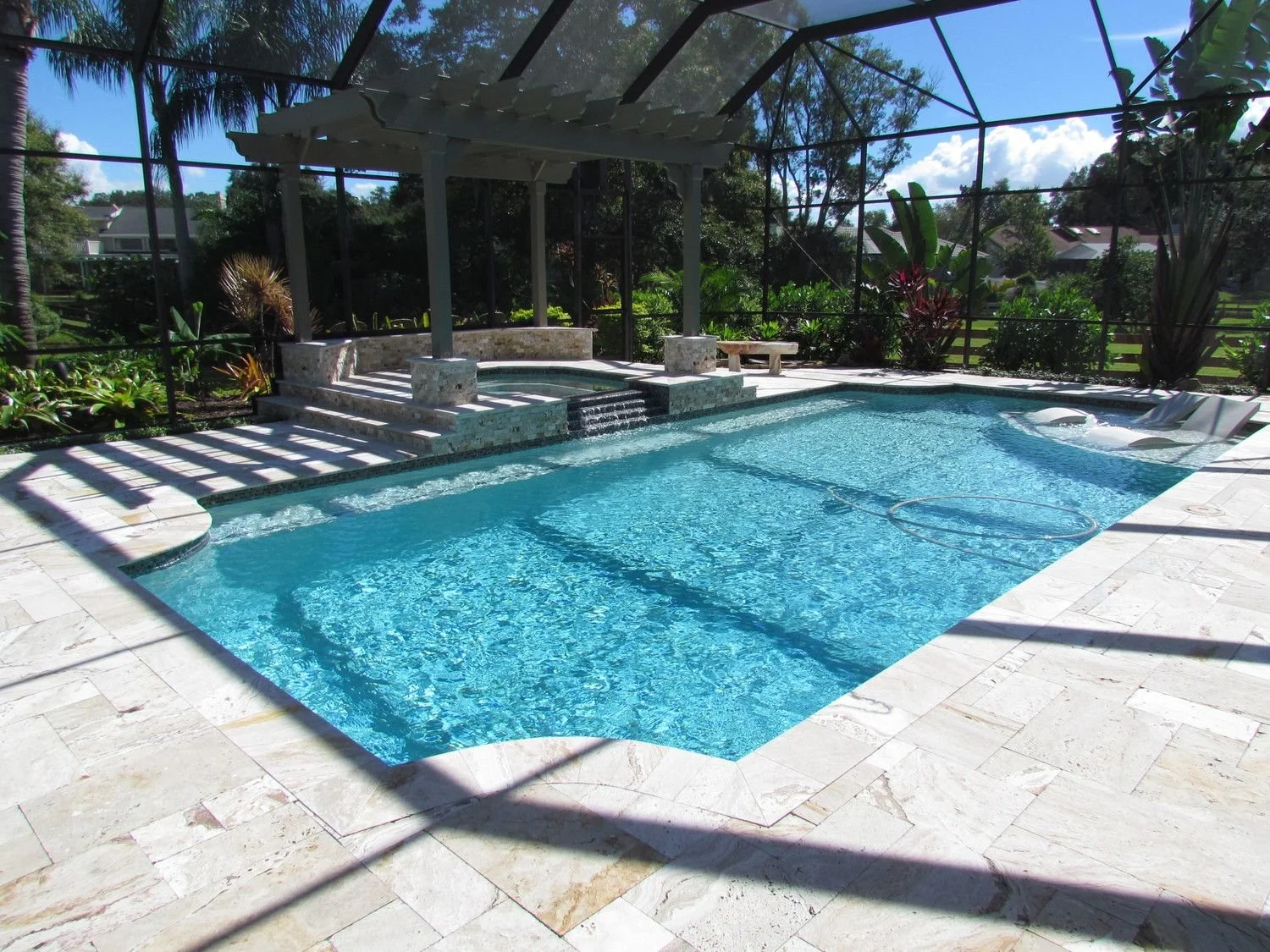 Wide screened pool under a pergola