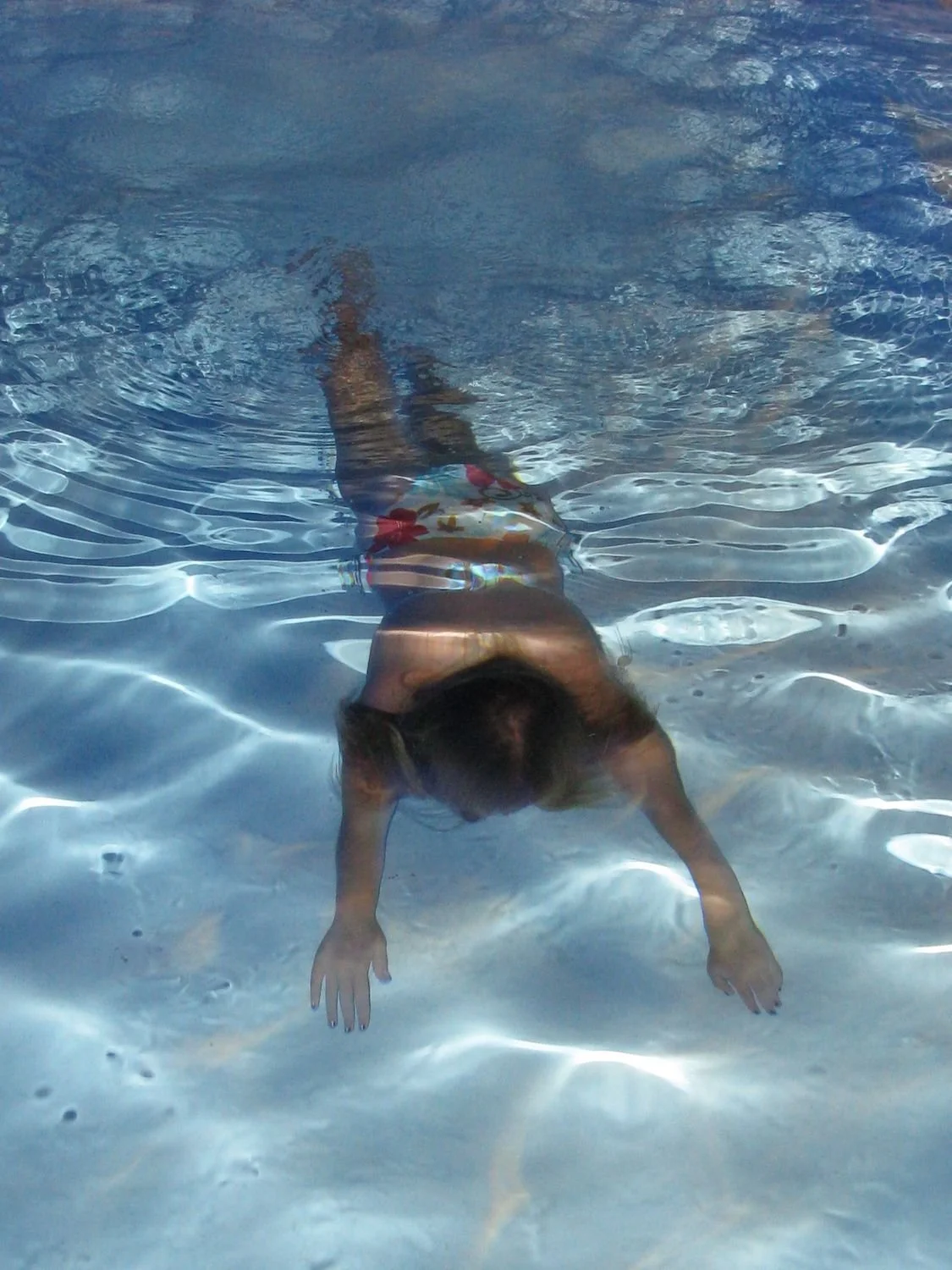 Swimmer underwater in a clear pool