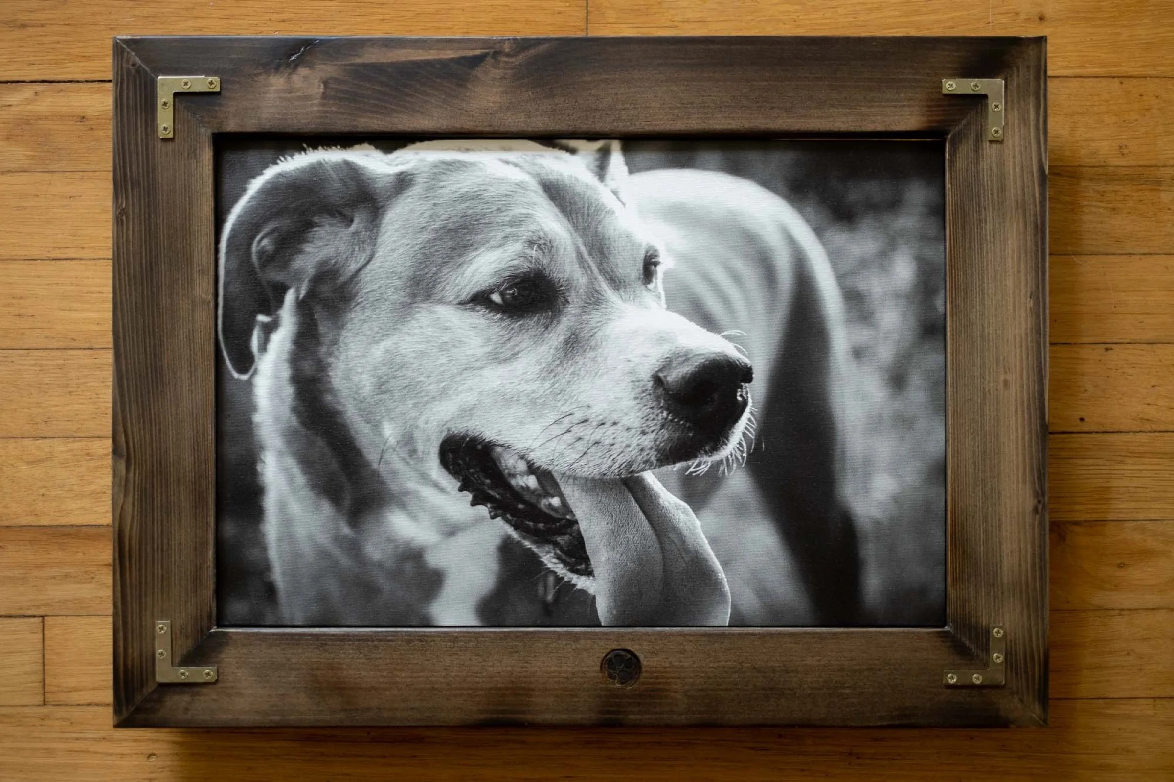 Handcrafted dark wood frame with brass corner details