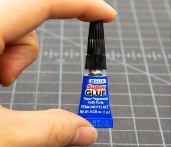 The first attempt used super glue and ripstop fabric, but the bond was too rigid and did not hold air.