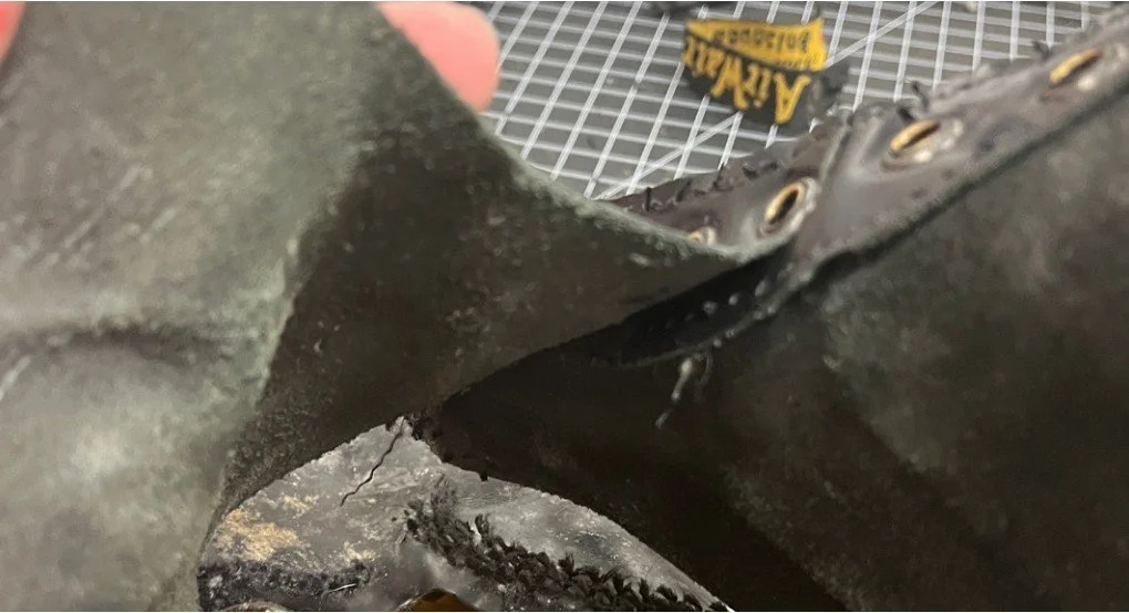 Boiling shoe to remove glue which holds sole to leather.