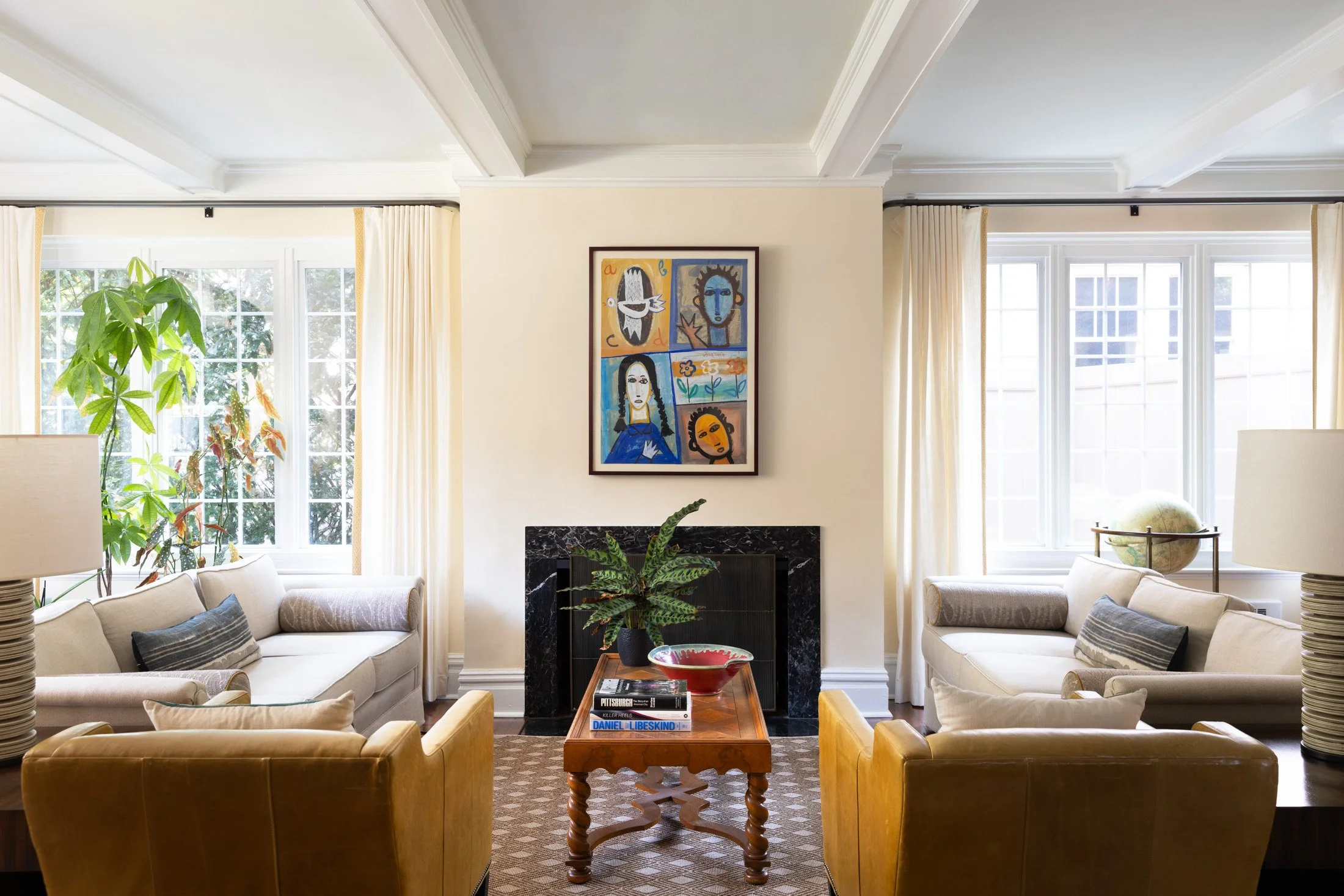 Squirrel Hill living room with a coffered ceiling, cream sofas, gold velvet chairs and colorful art