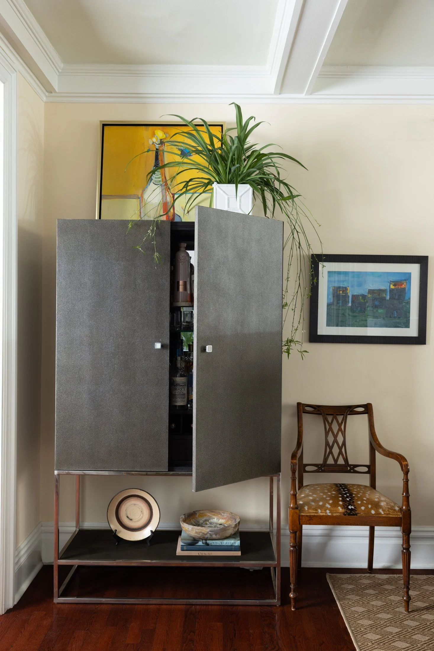 Open gray cabinet showing its interior storage in the Squirrel Hill living room