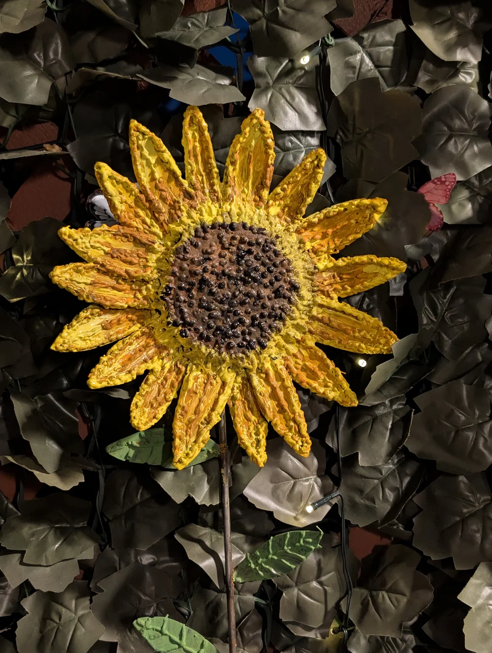 Eric J. Cox’s welded sunflower sculpture with yellow petals and a textured brown center