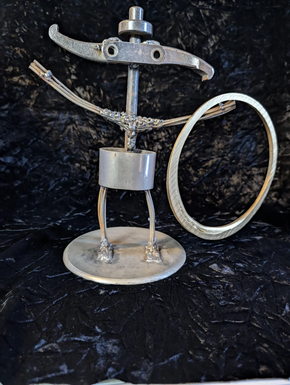 Bob, Eric J. Cox’s welded metal character with outstretched arms and a large metal ring