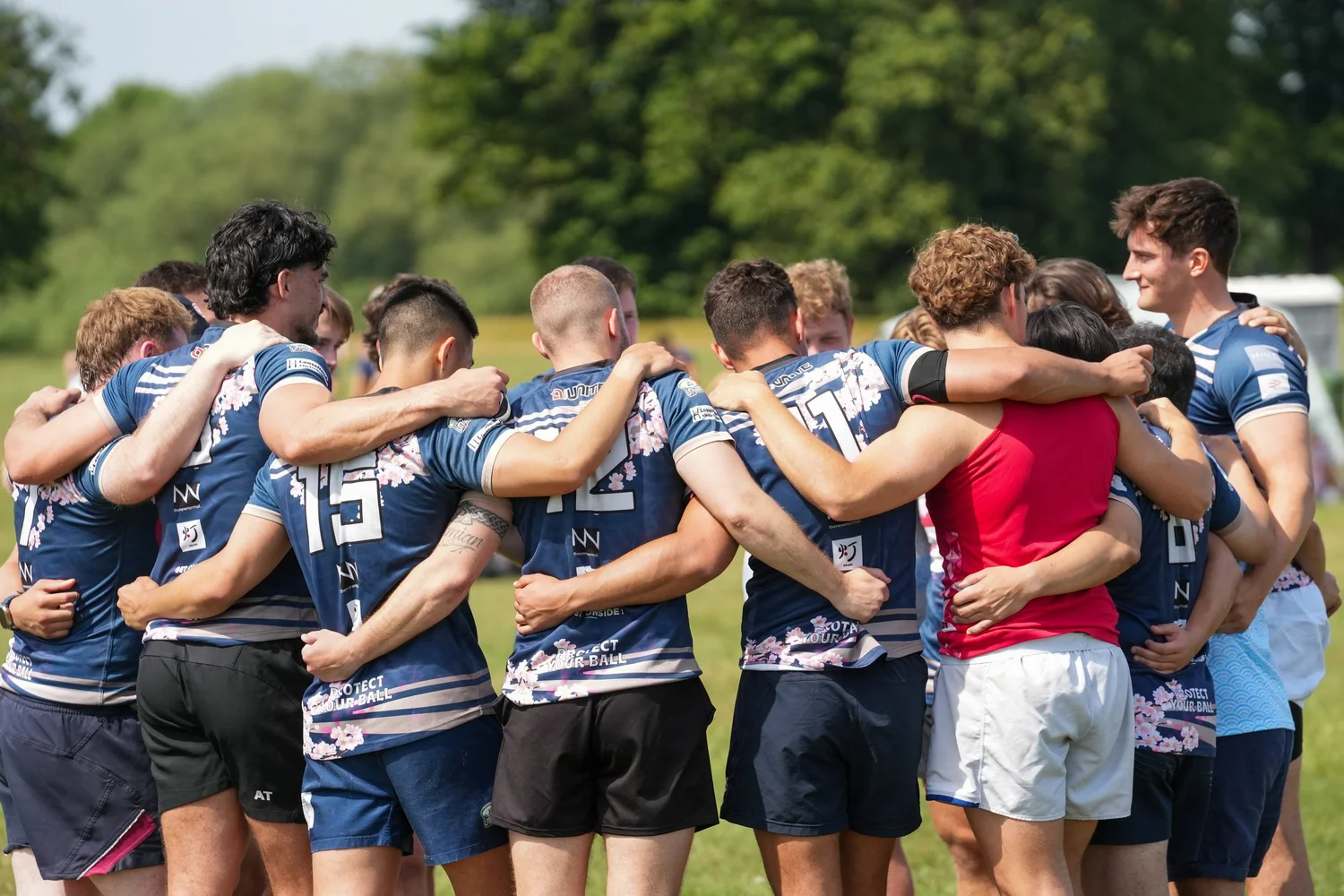 Rugby sevens team huddle at Summer Social
