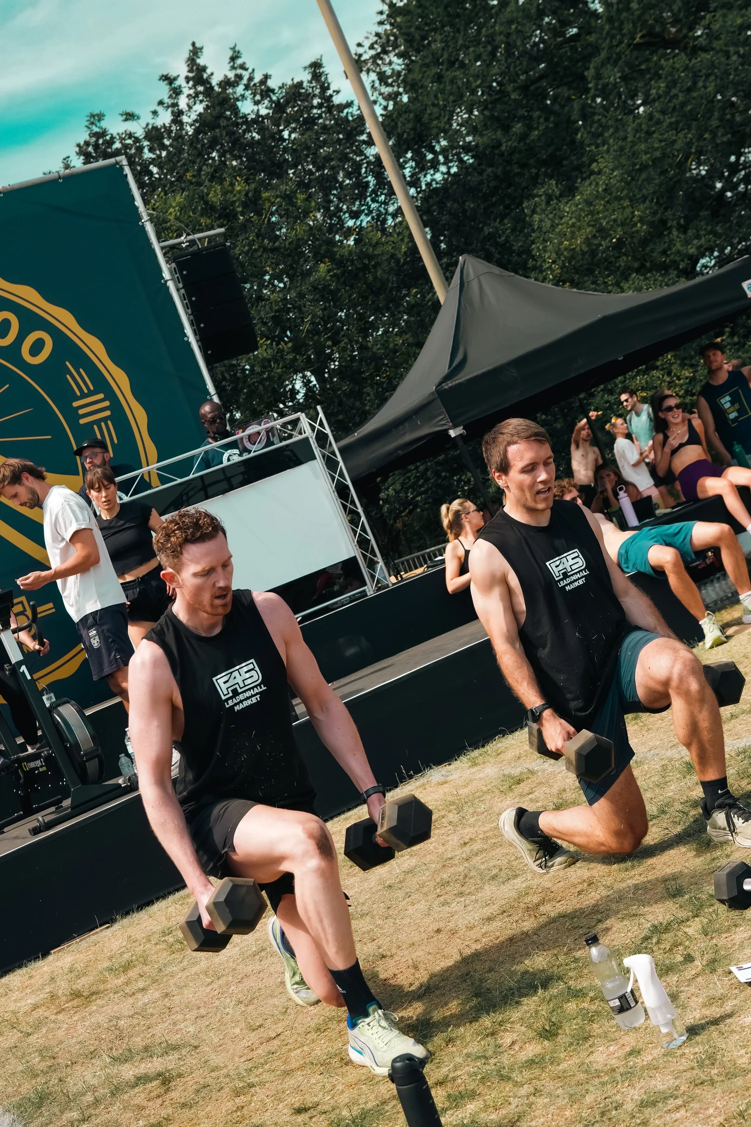 Two F45 PEAK500 competitors performing dumbbell lunges