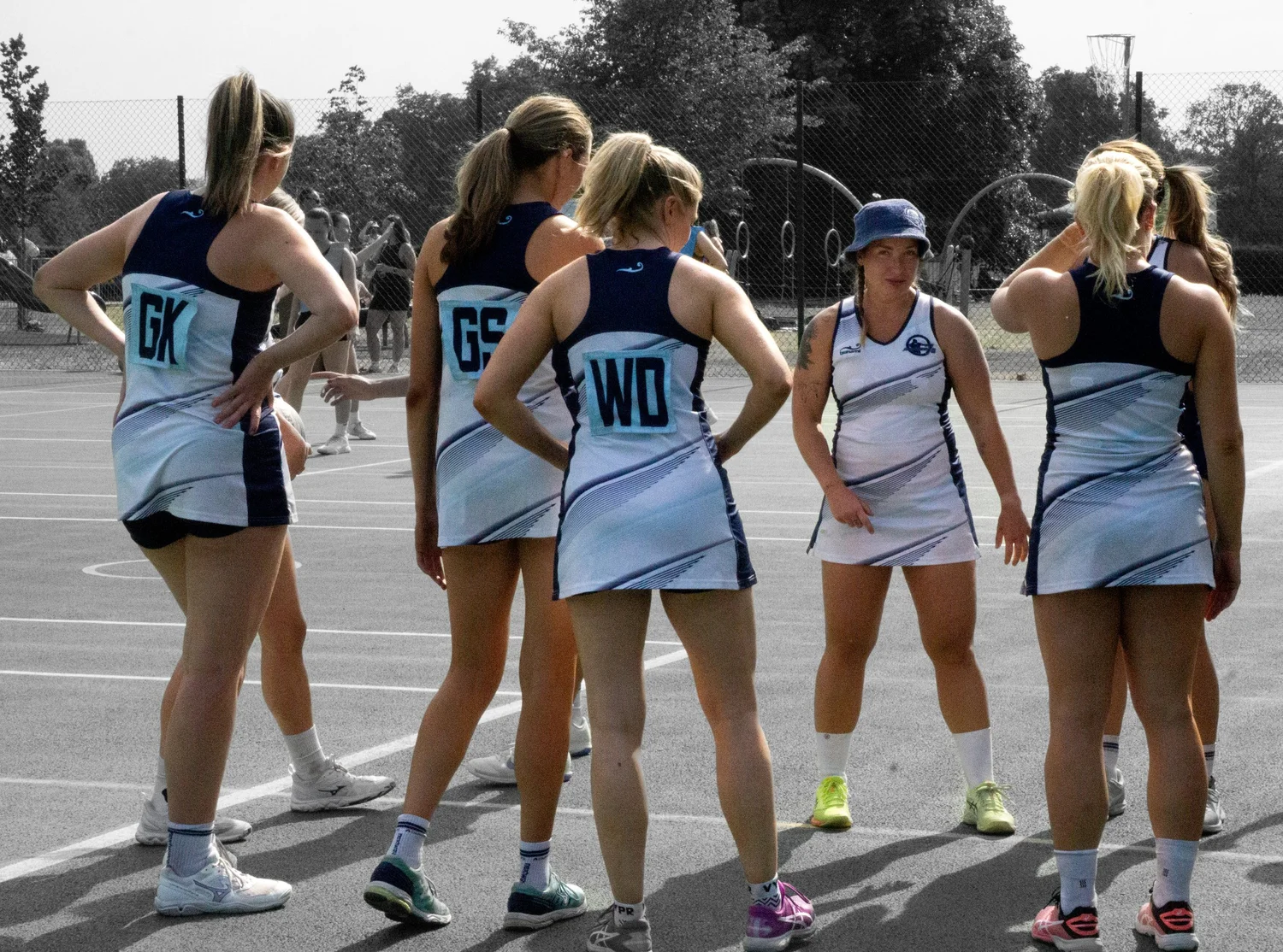 Netball teammates gathering on court