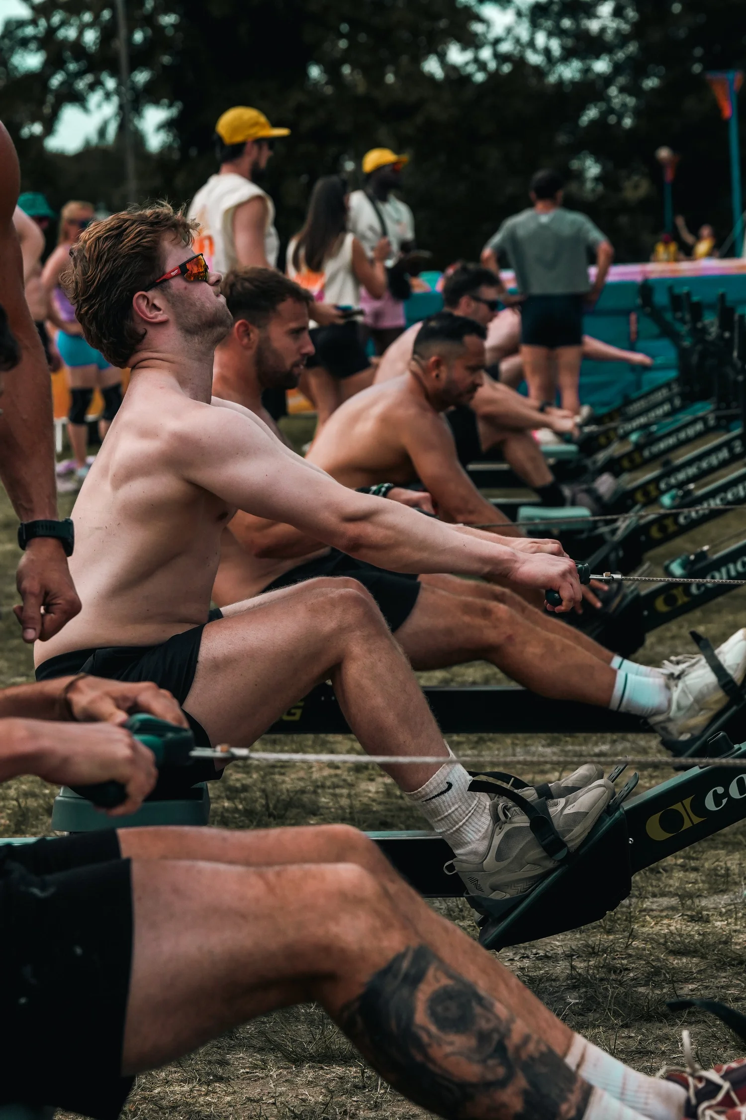 Athletes competing side by side on the Throwdown rowing floor