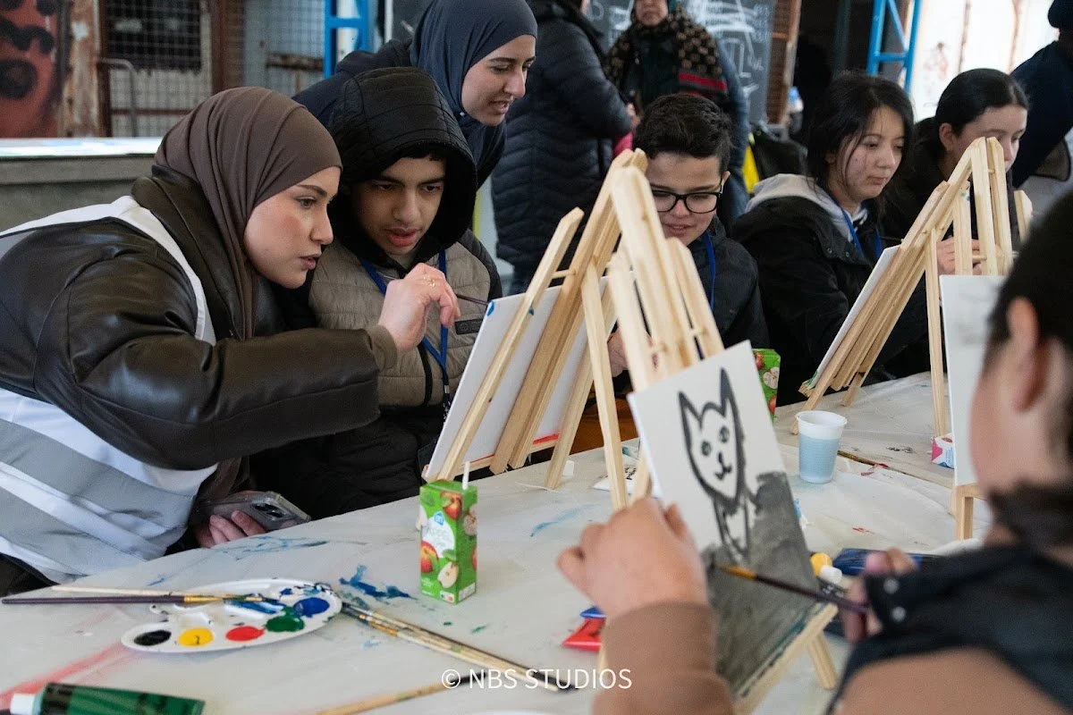 Children painting on easels at a creative workshop