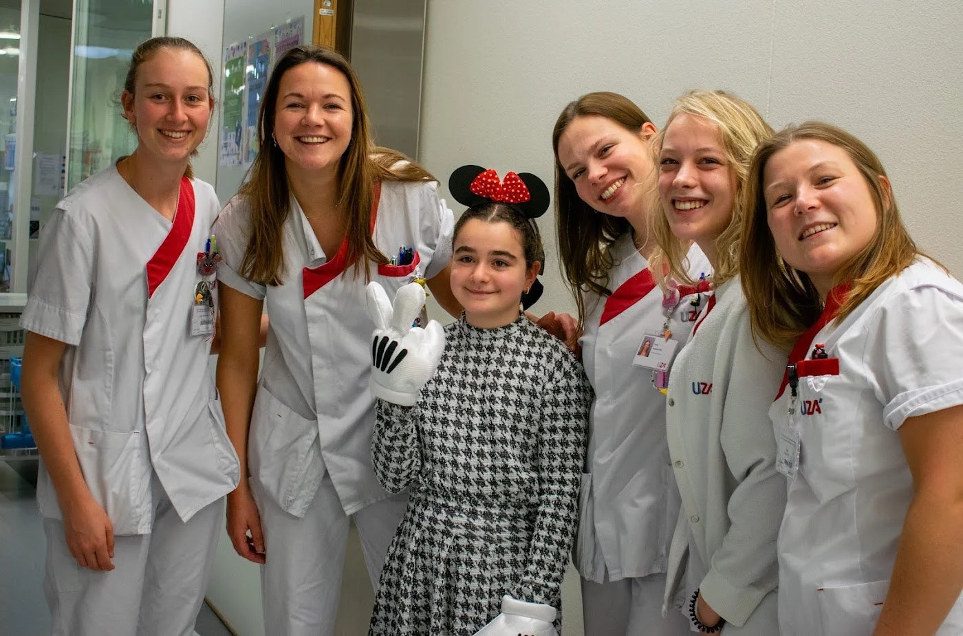 Hospital staff and a young patient during a Make A Kid Happy hospital visit with a partner