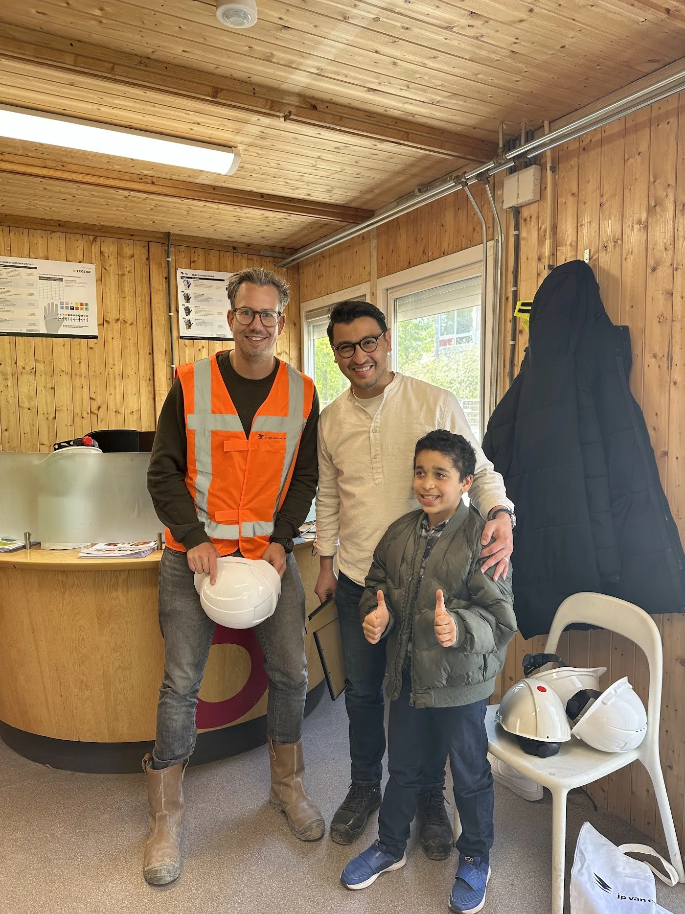Driss giving a thumbs up with the construction team on the day his wish came true