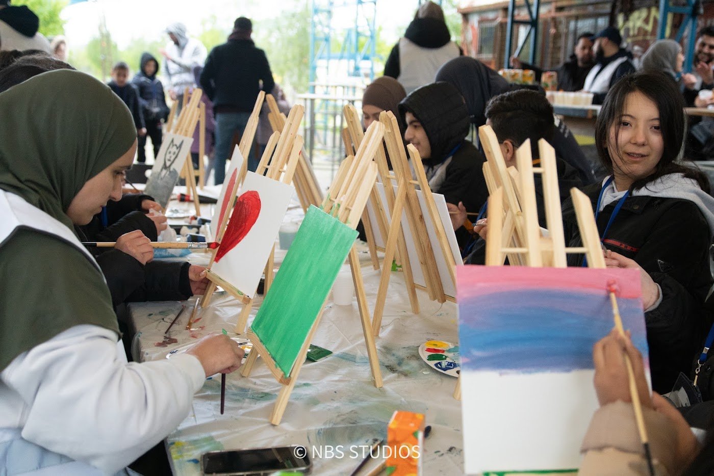 Children painting together at a creative workshop organised by Make A Kid Happy