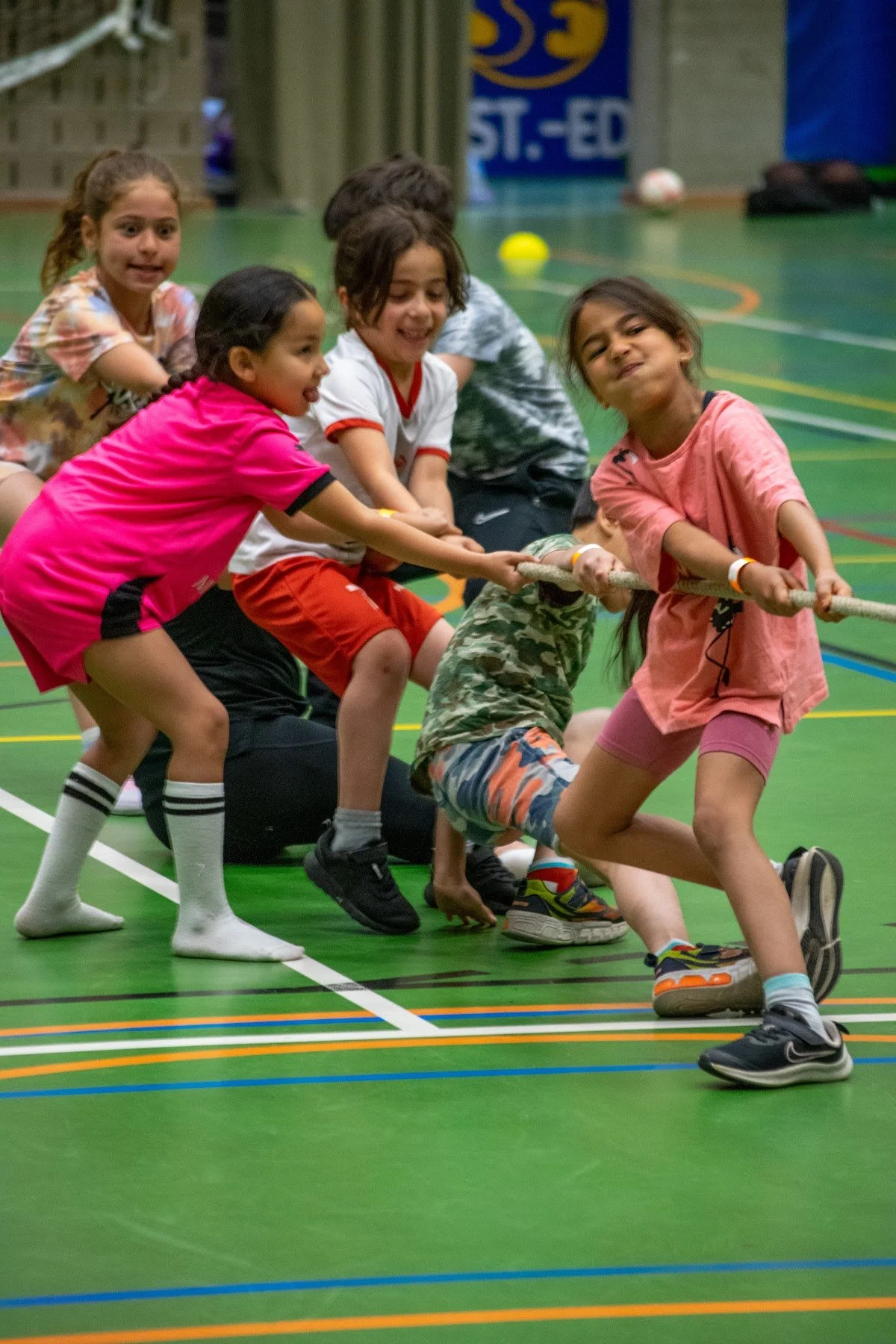 Girls pulling together in a tug of war