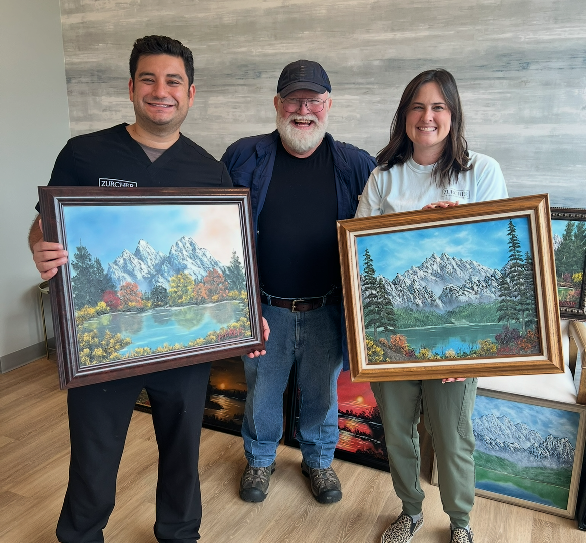 Johnny with Dr. and Mrs. Michael Zurcher and their two original paintings