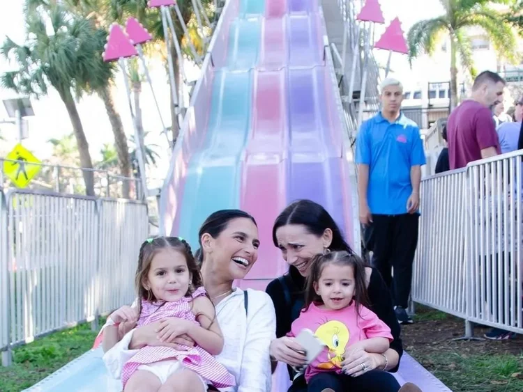 Family riding down a giant festival slide