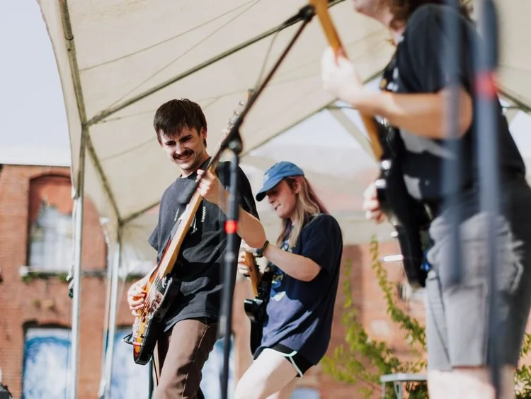 Band performing live on an outdoor stage