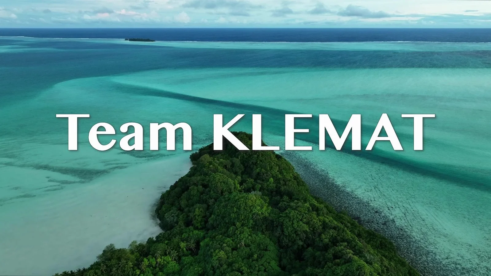 Aerial view of a turquoise lagoon and a forested island in Palau