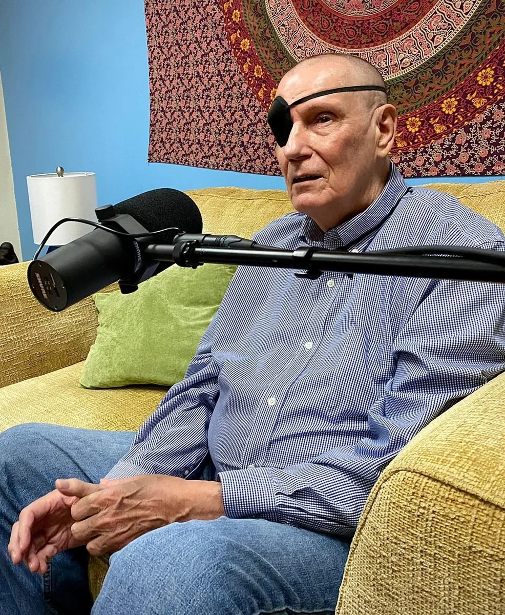 A guest listens at a studio microphone during a recording