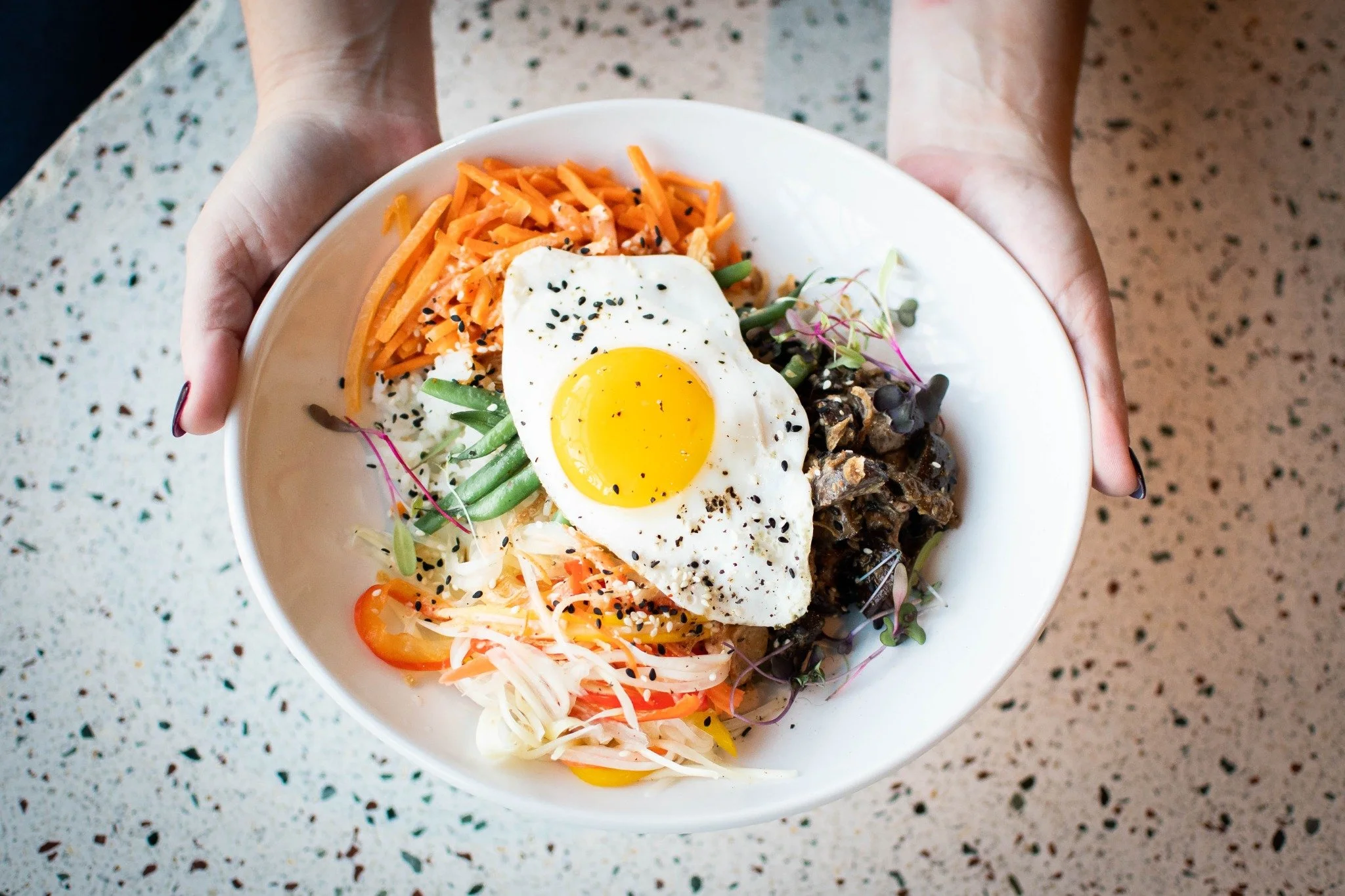 SOB bowl topped with a sunny-side egg
