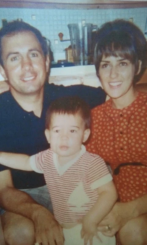 Nick's mom and dad, with Nick as a toddler