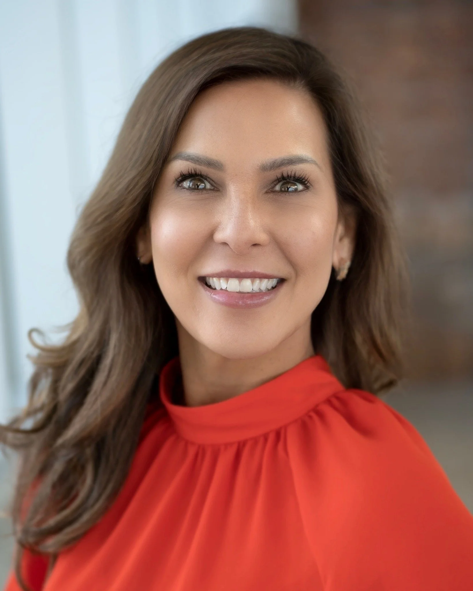 Steph Shannon smiling in a red blouse