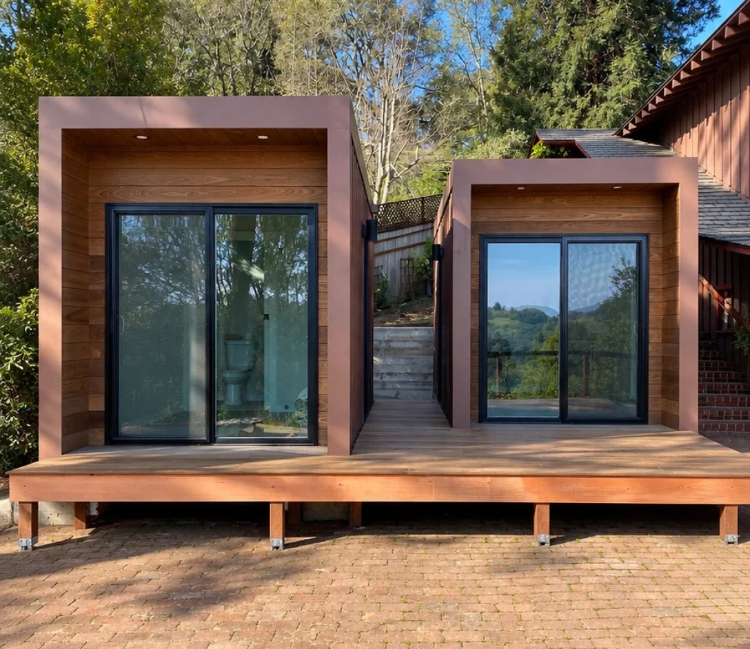 Two ADUs with wood siding on a deck
